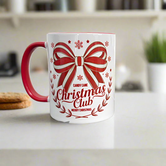 White mug with red handle featuring a candy cane Christmas Club design on a kitchen counter.